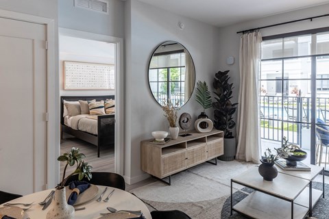 a living room with a large mirror on the wall at Leena Plantation, Florida